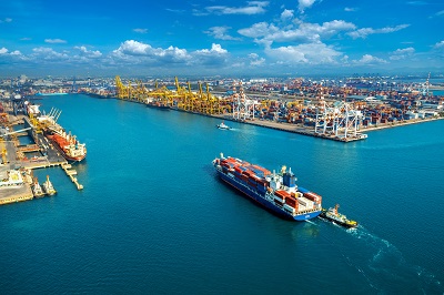 Aerial view of cargo ship and cargo container in harbor.